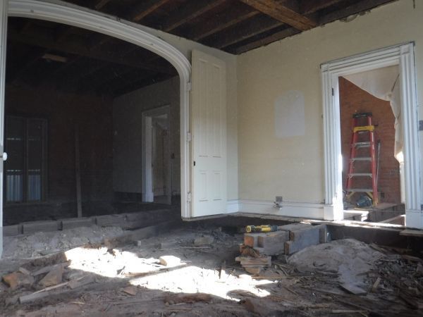 An empty room with a ladder in the background.