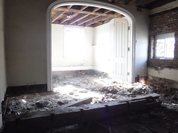 An empty room with a door and a window.