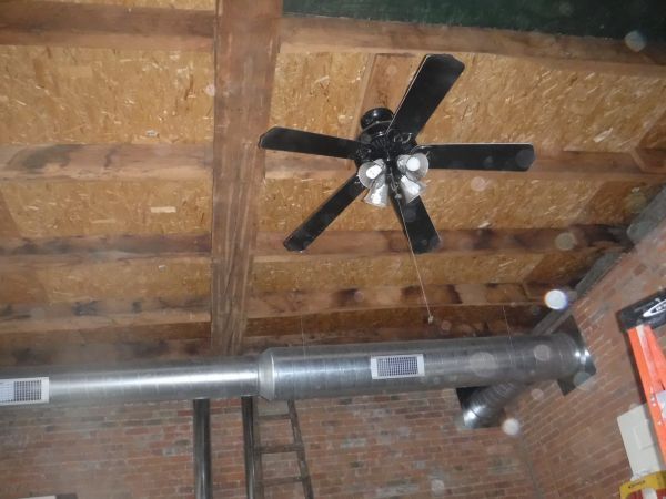 A ceiling fan is hanging from the ceiling of a building.