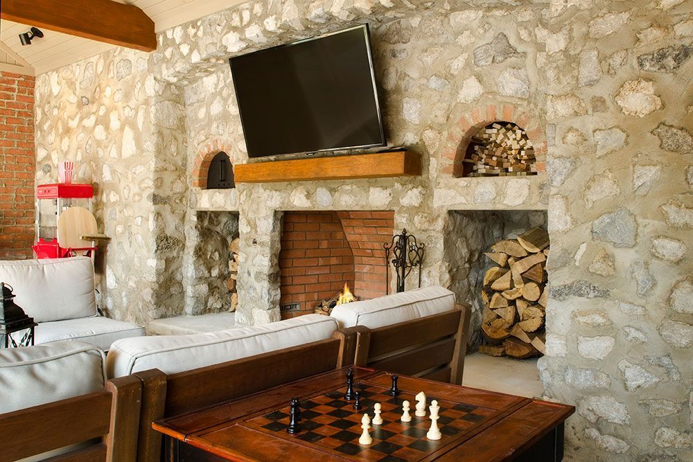 There is a chess board on the table in a pool house room.