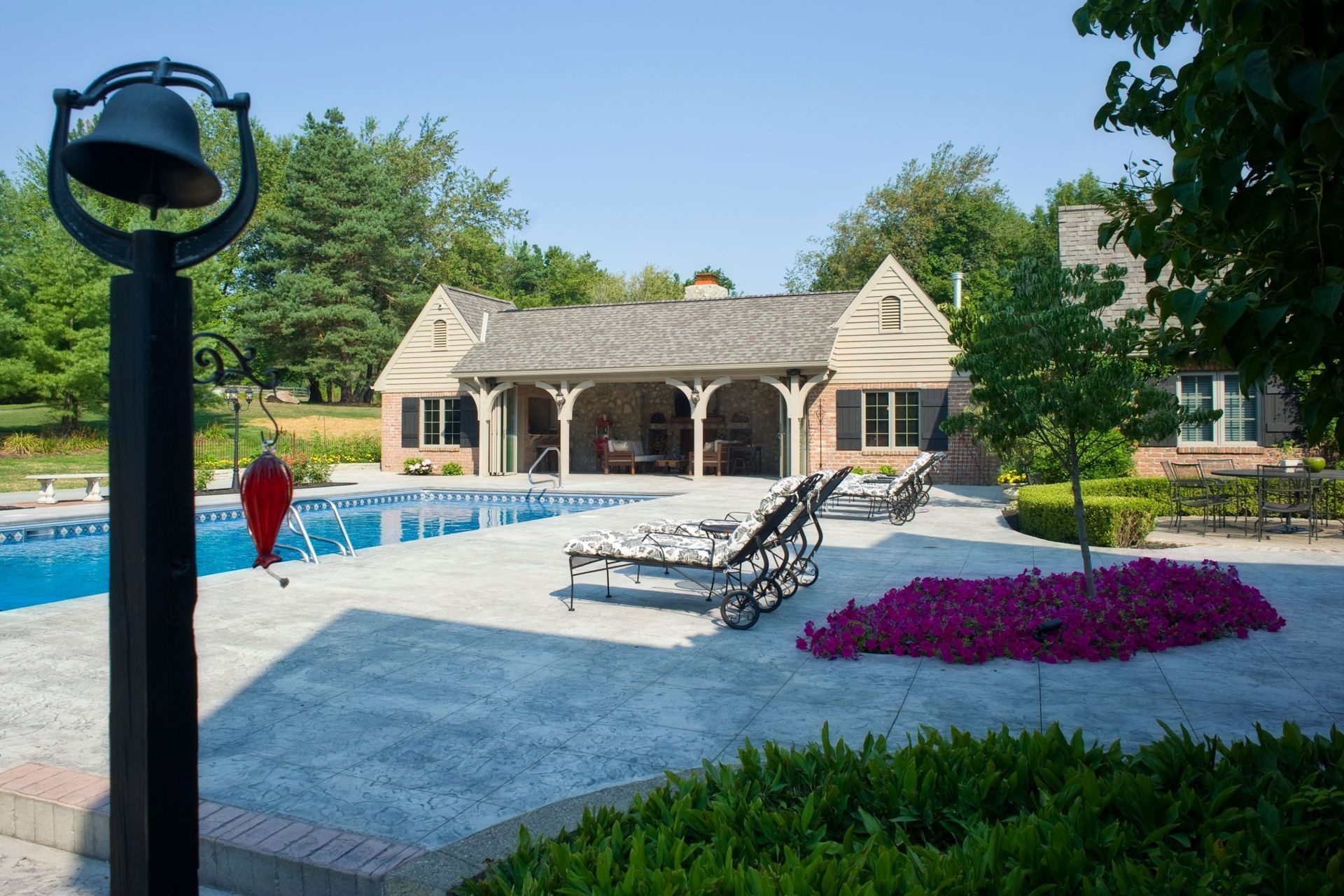 A large house with a swimming pool in front of it.