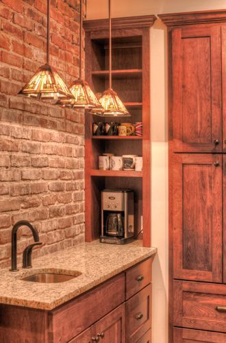 A kitchen with a sink and a coffee maker.