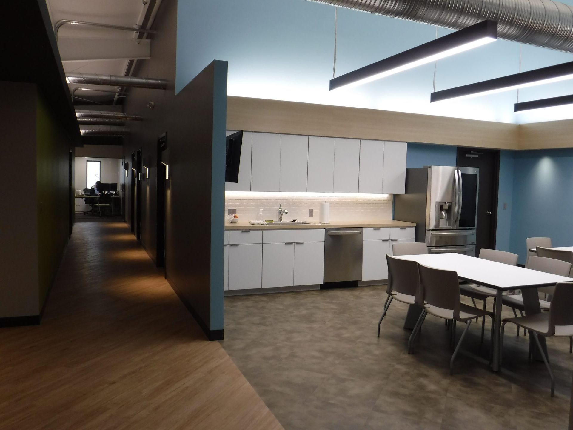 A kitchen with white cabinets and stainless steel appliances.