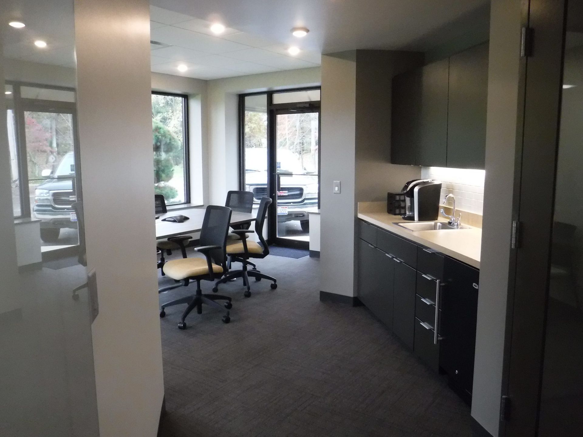 A room with a lot of windows and chairs.