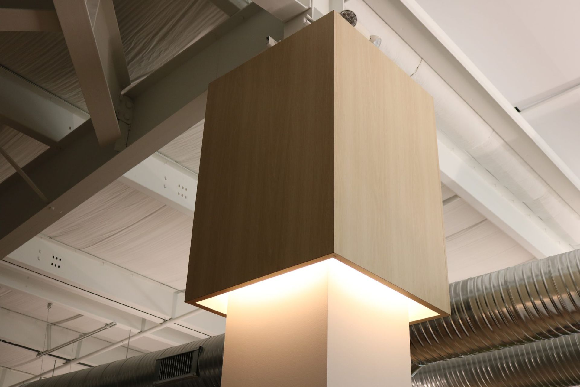 A wooden cube with a light inside of it.