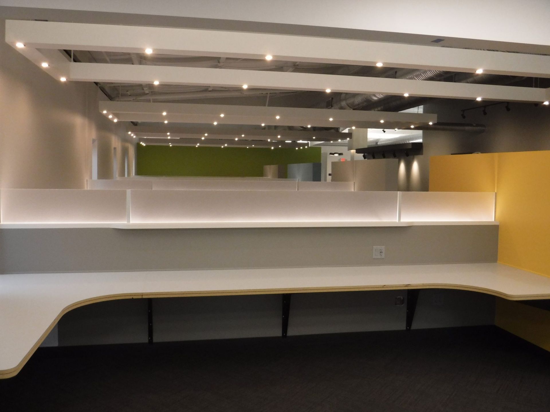 An empty office with cubicles and a ceiling light.