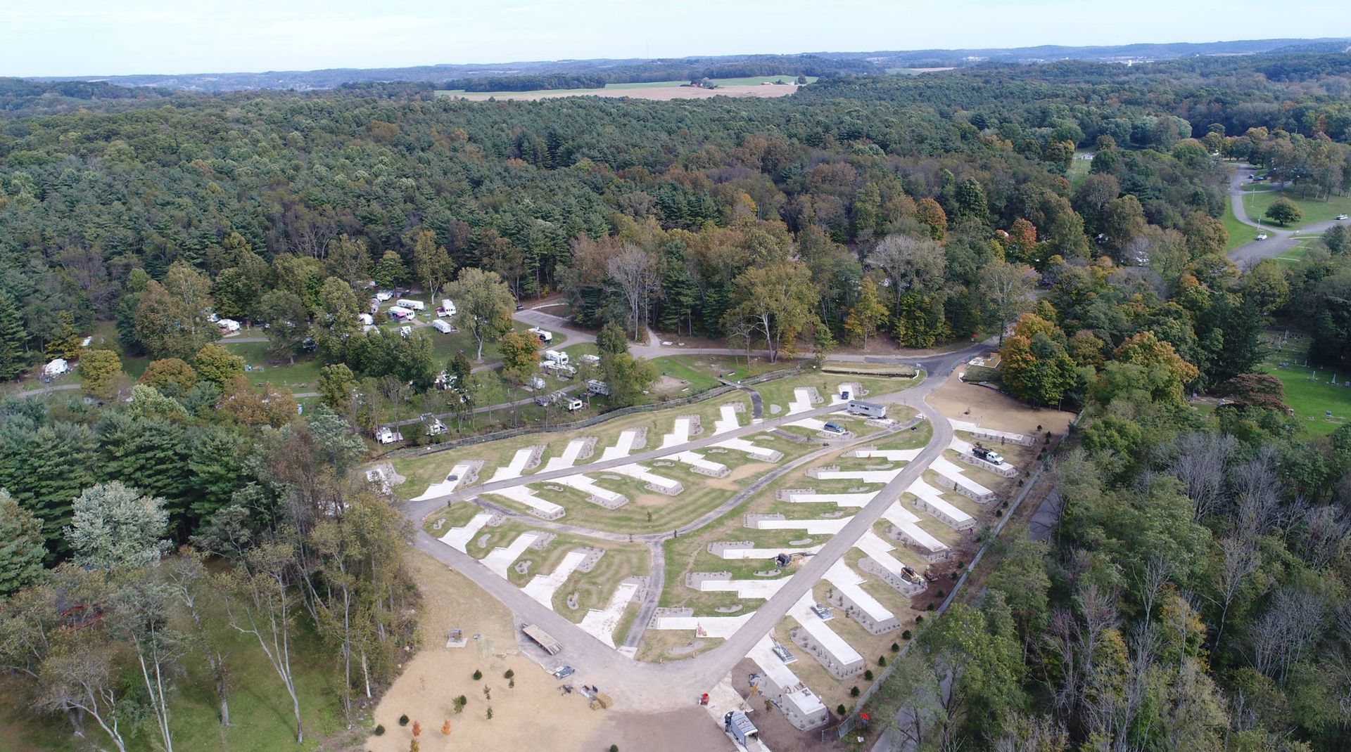 An aerial view of a campground surrounded by trees.