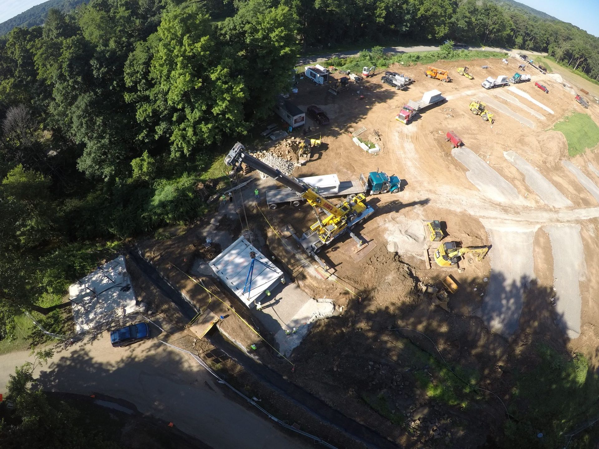 An aerial view of a construction site surrounded by trees.