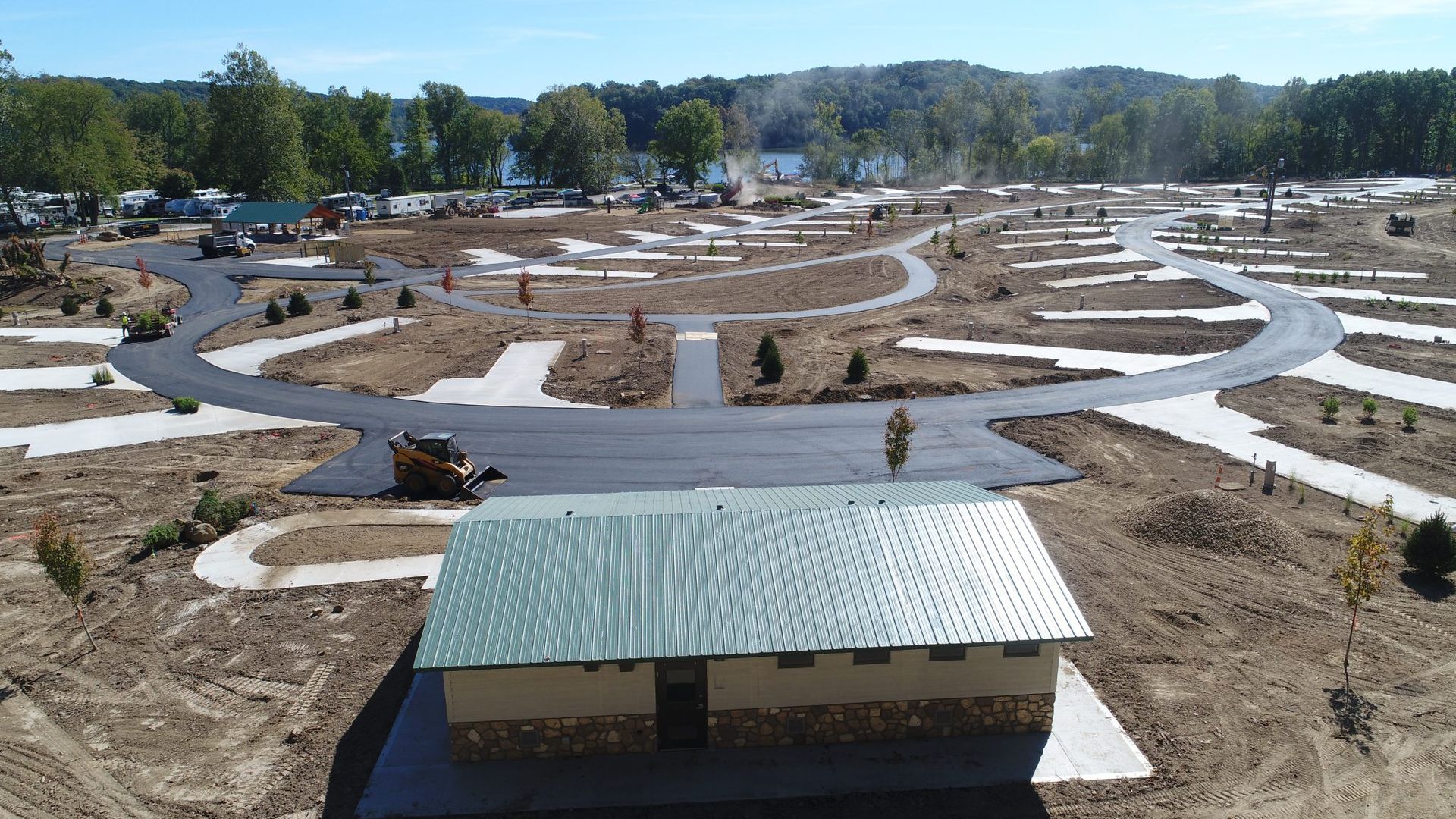 An aerial view of a small house in the middle of a dirt field.
