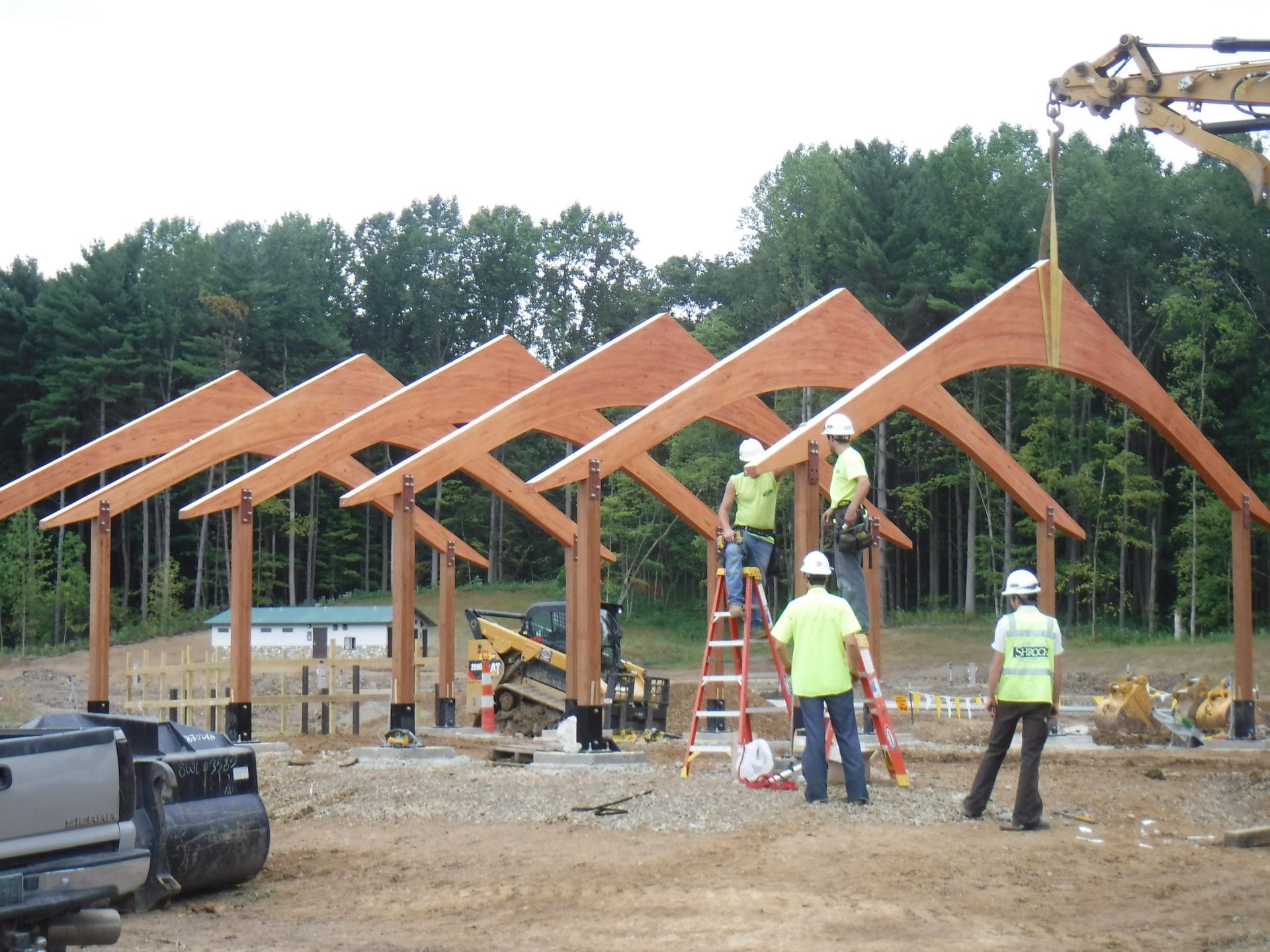 A group of construction workers are working on a wooden structure.