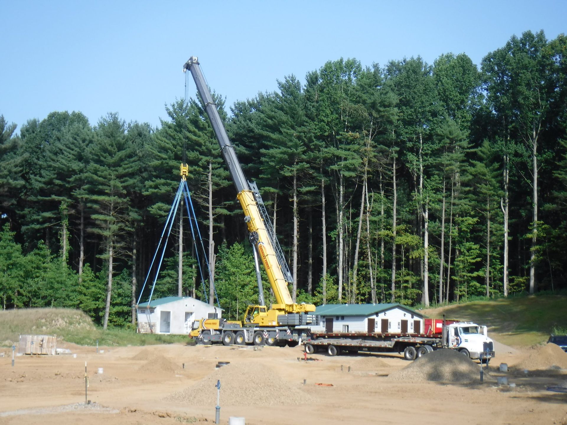 A construction site with a crane and a truck.