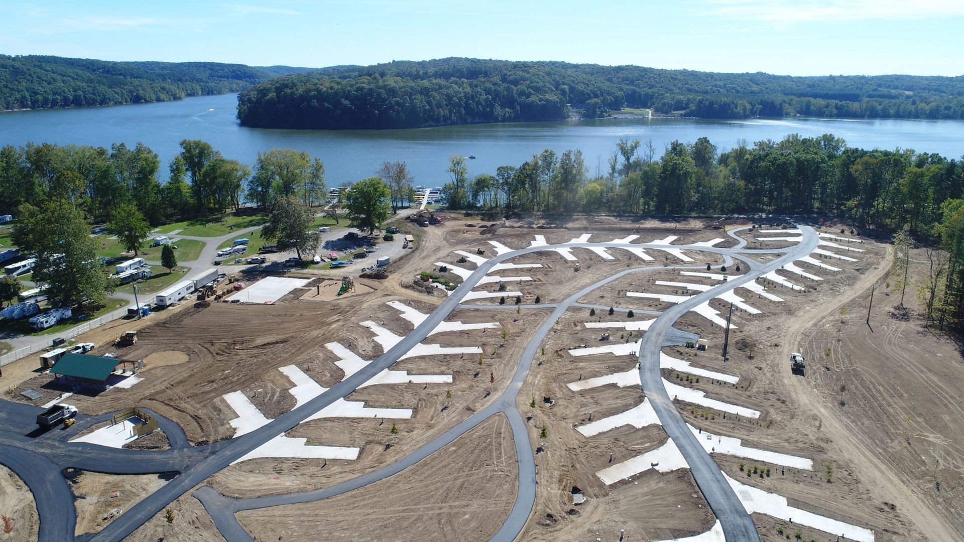 An aerial view of a campground with a lake in the background.