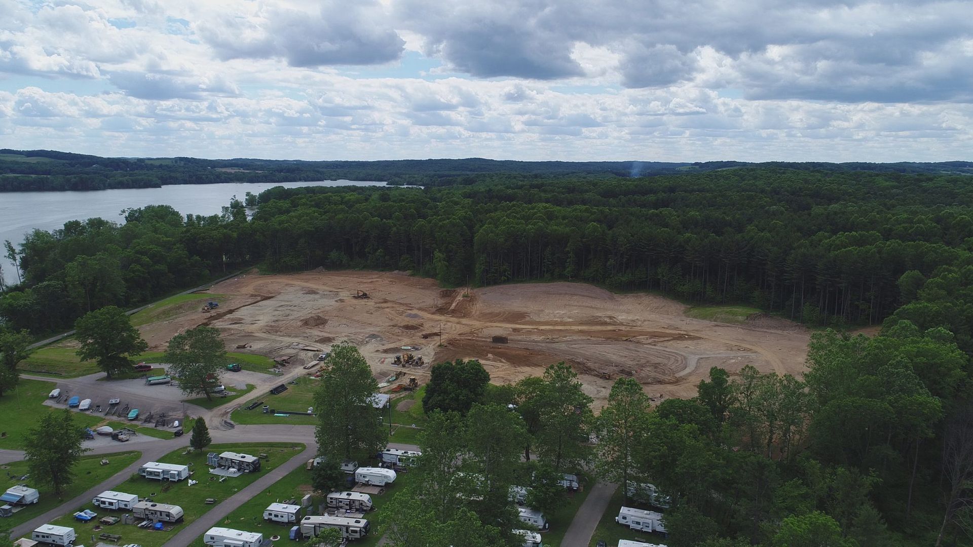 An aerial view of a campground with a lake in the background.