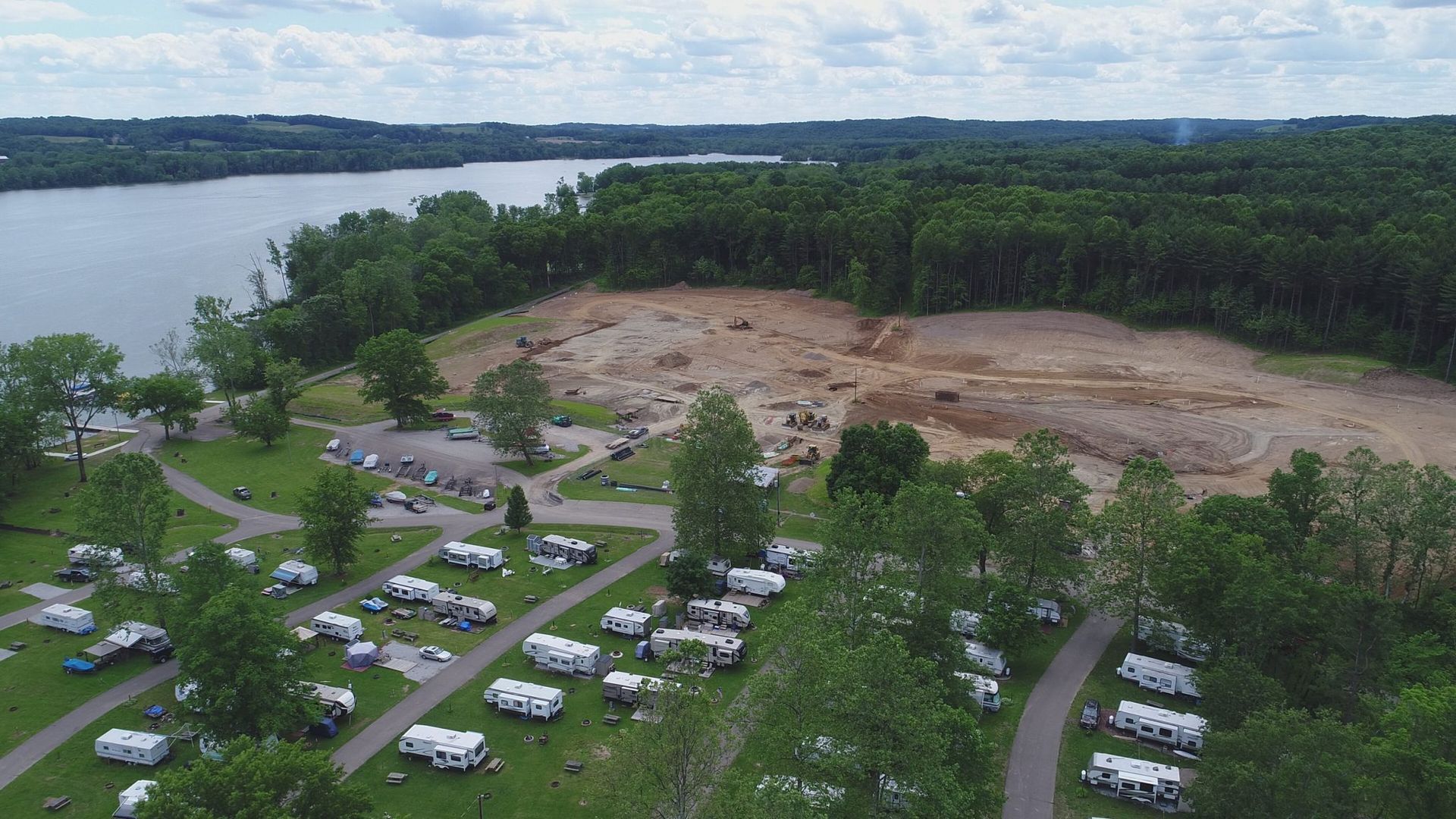 An aerial view of a campground with a lake in the background.