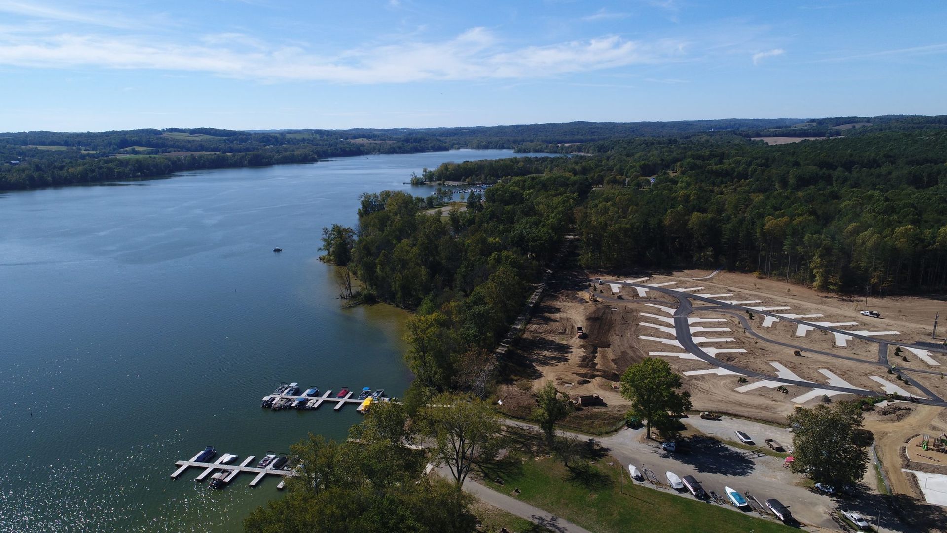 An aerial view of a lake with boats docked in the water.