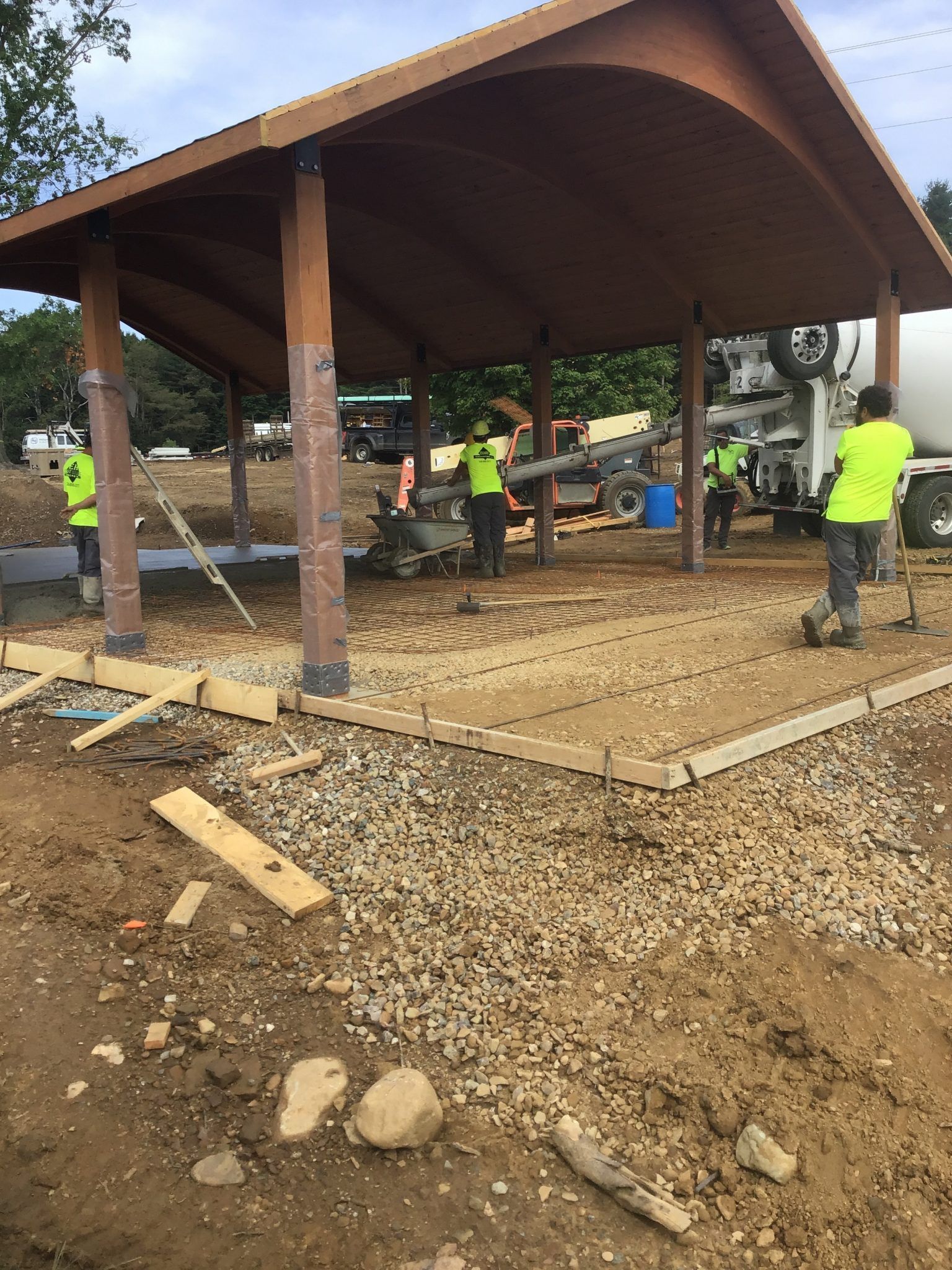 A team of construction workers are working on a pavilion.