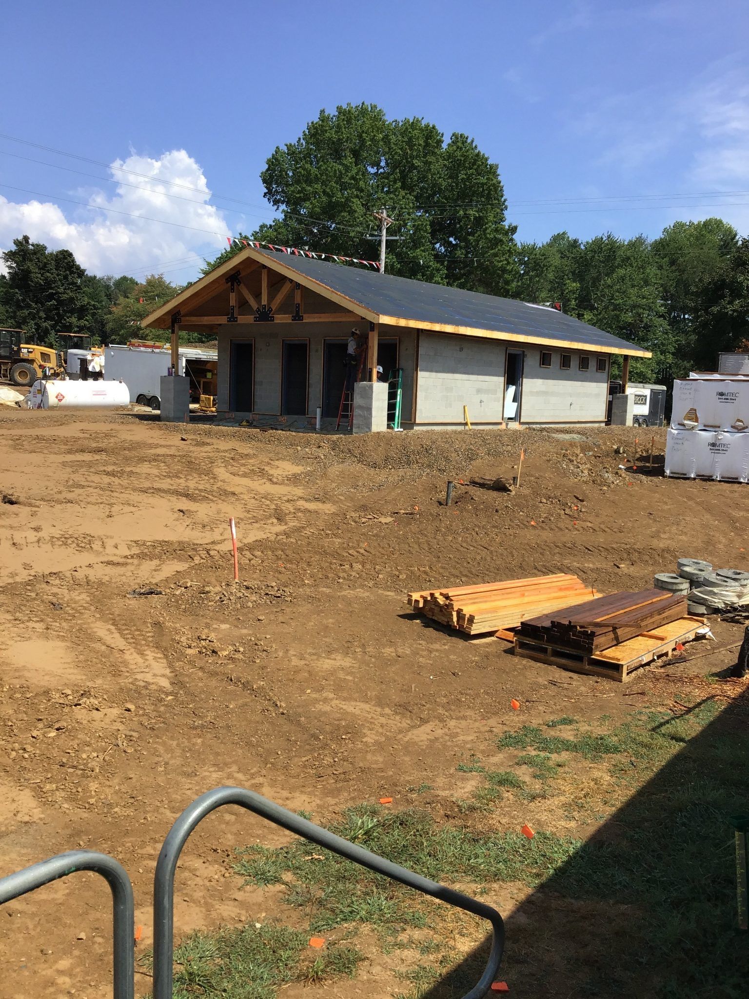 A house is being built in a dirt field.