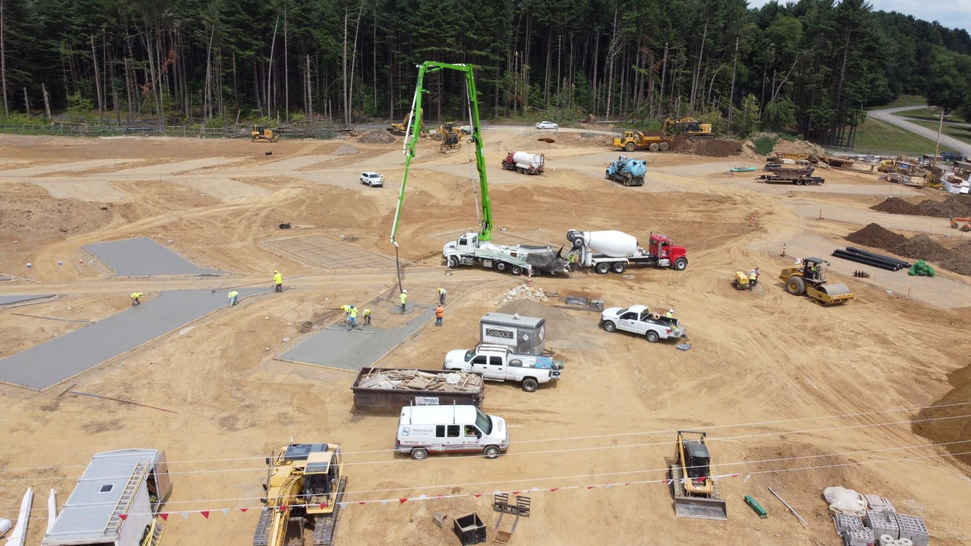 An aerial view of a construction site with trucks and tractors.