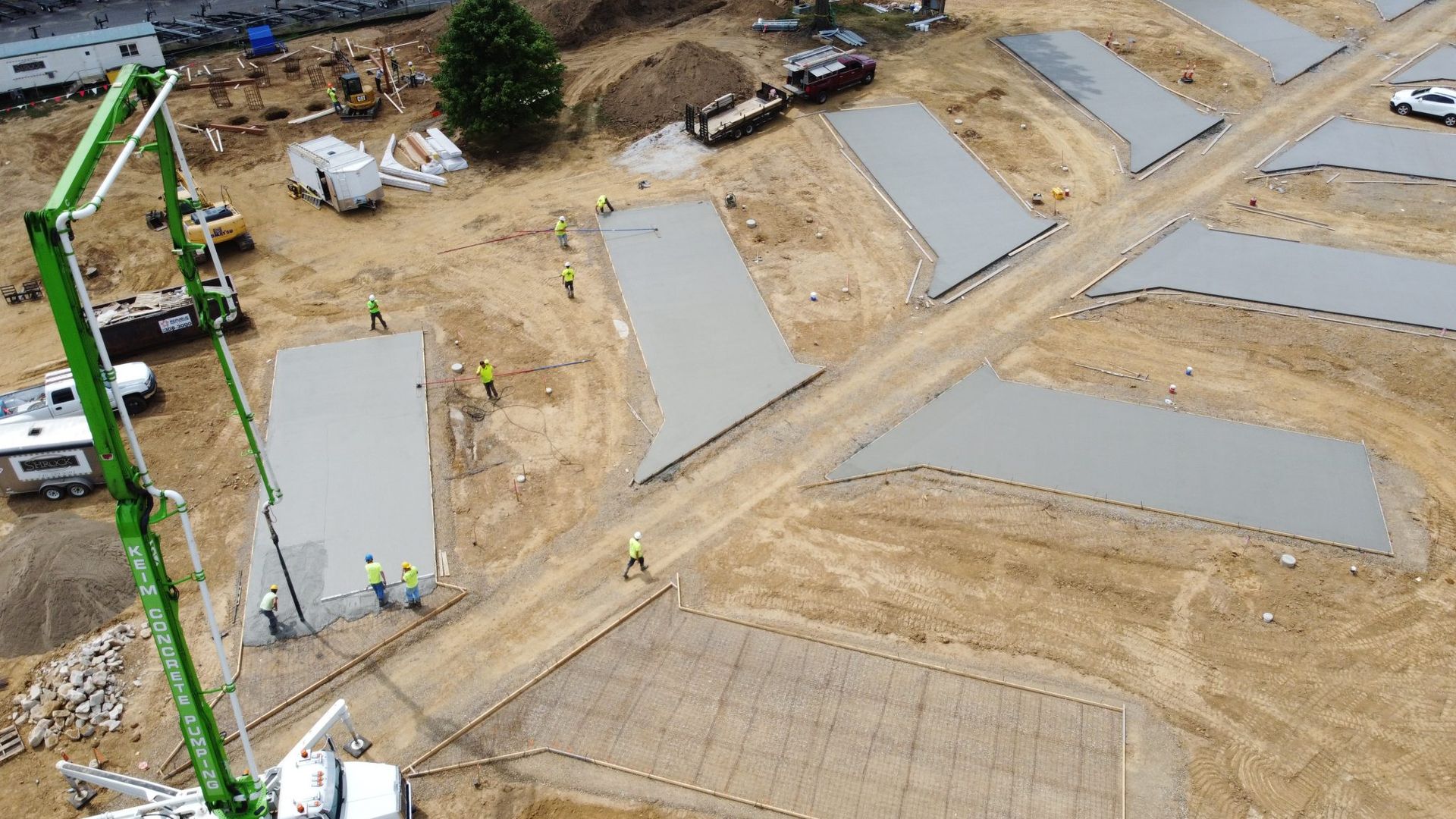 An aerial view of a construction site with a green crane.