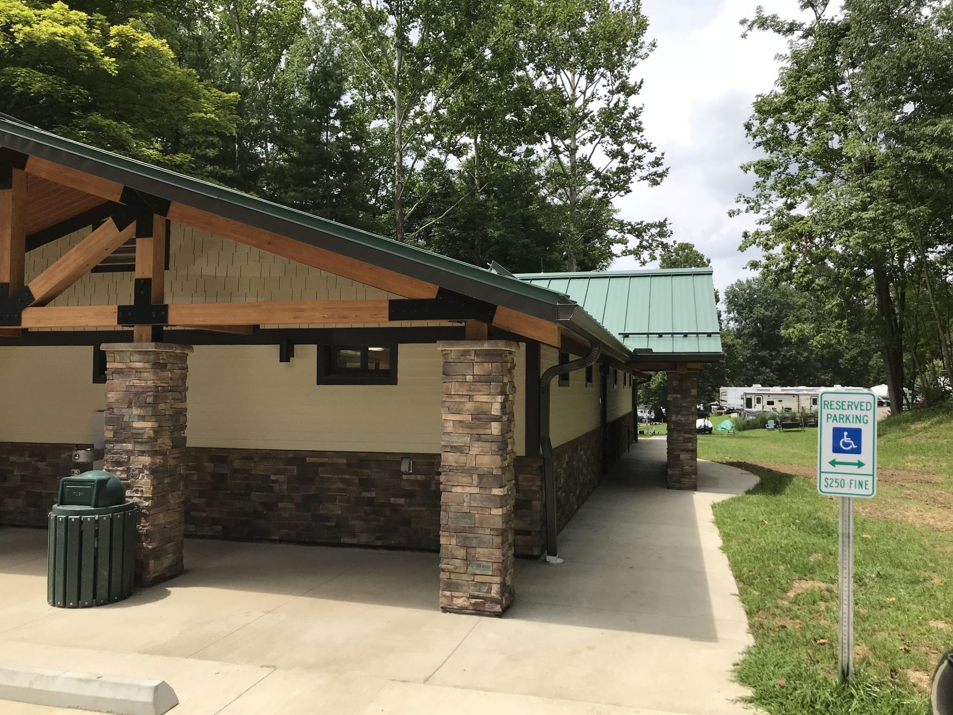 A small building with a handicapped parking sign in front of it.