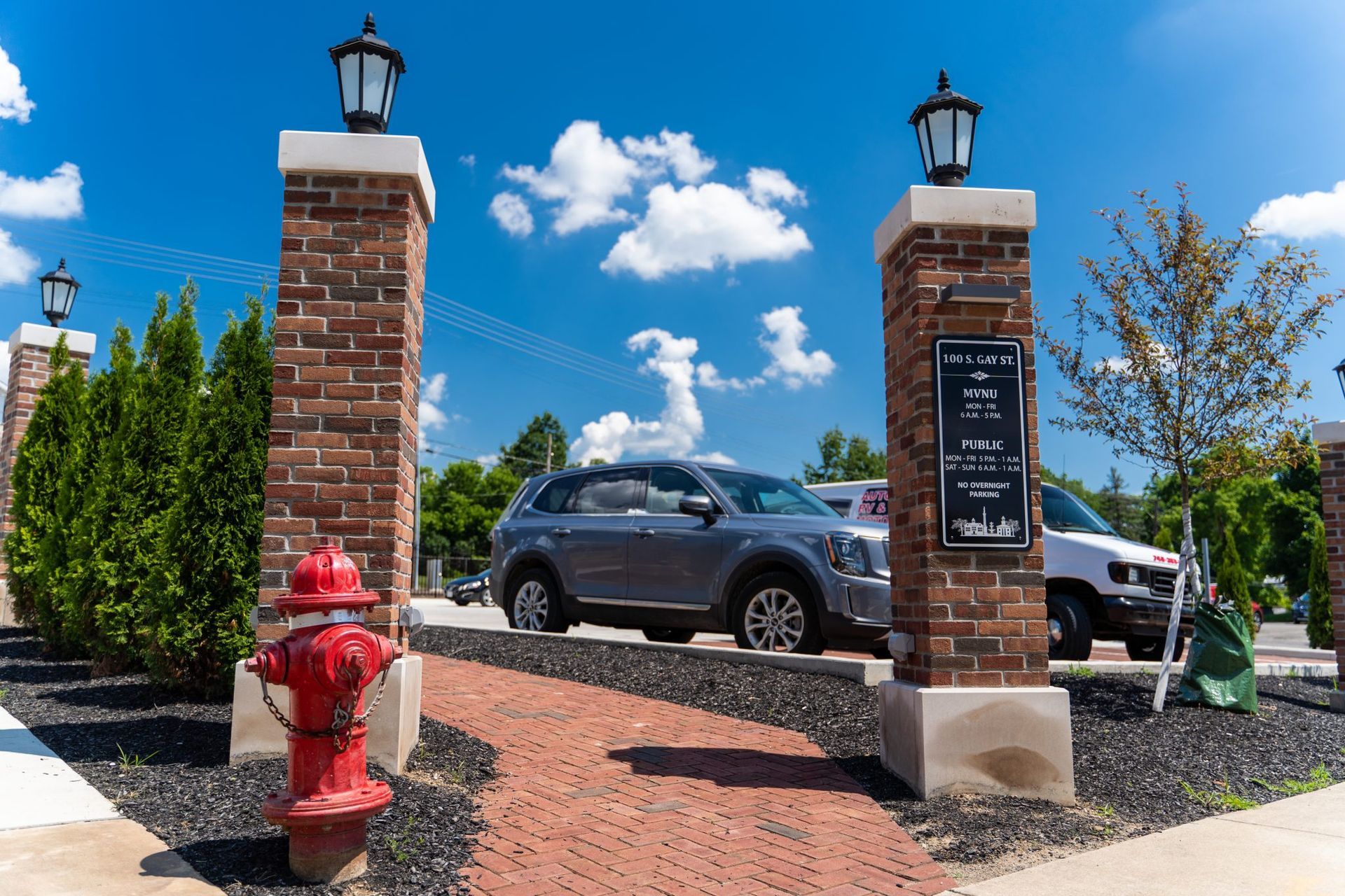 A fire hydrant is in front of a brick building.