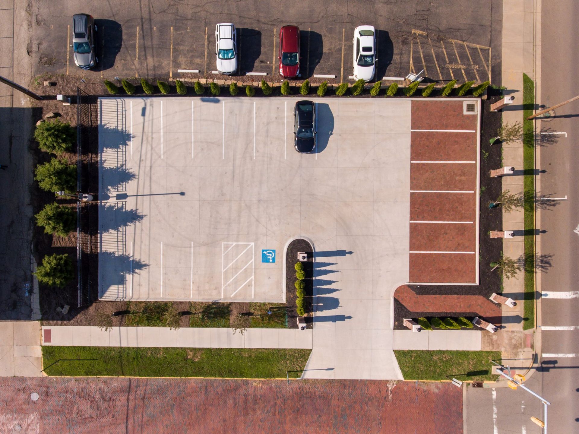 An aerial view of a parking lot with cars parked in it.