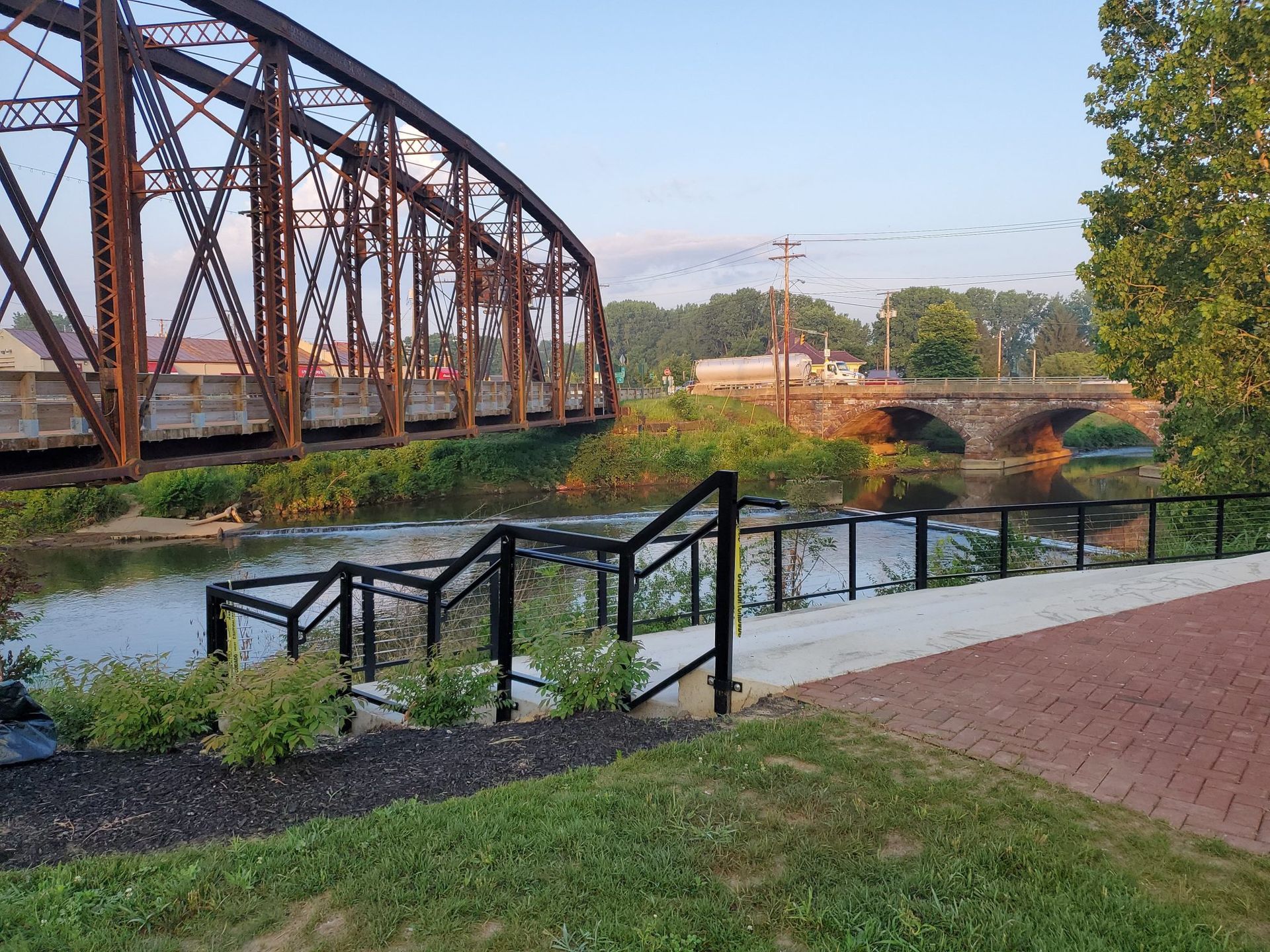 A bridge over a river with stairs leading to it.