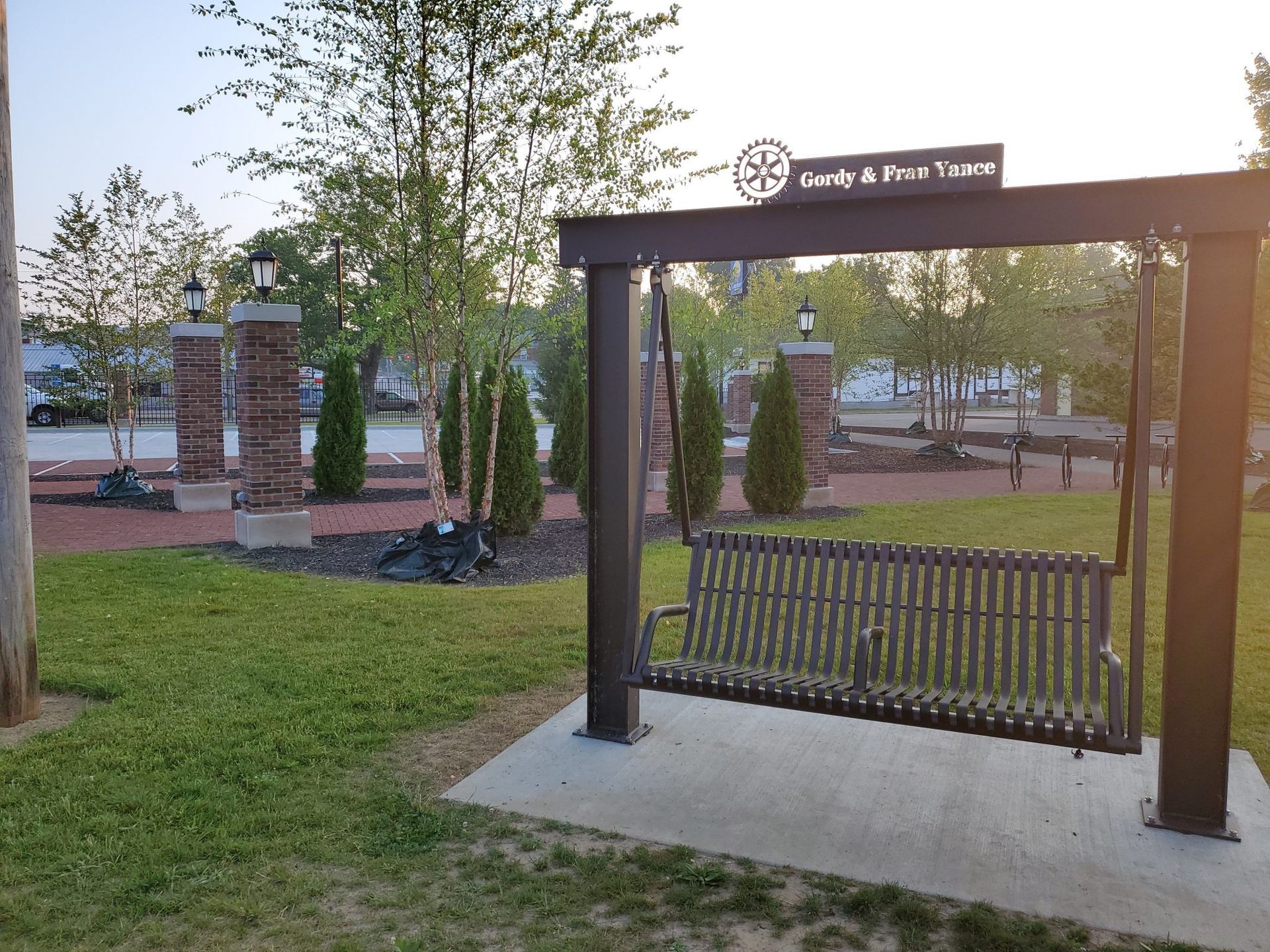 A park with a bench and a sign that says ' unity & free transit '