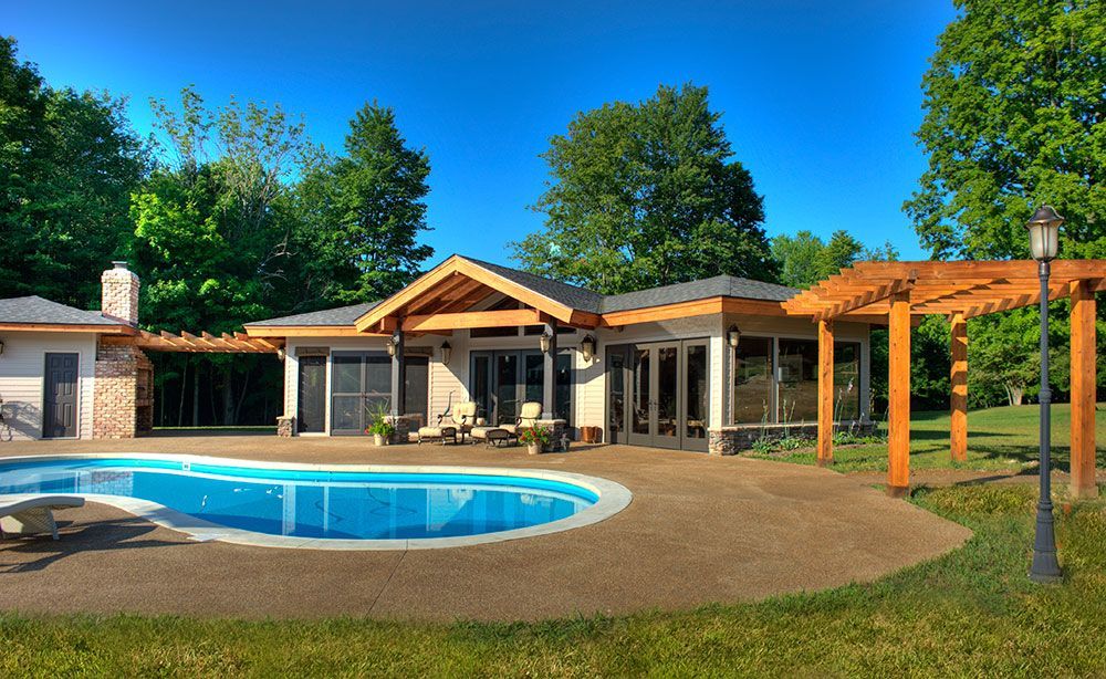 A large house with a large swimming pool in front of it