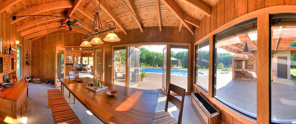 A large room with a long table and lots of windows