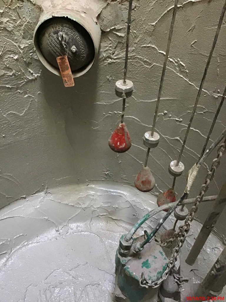 A close up of a metal objects hanging from chains. 