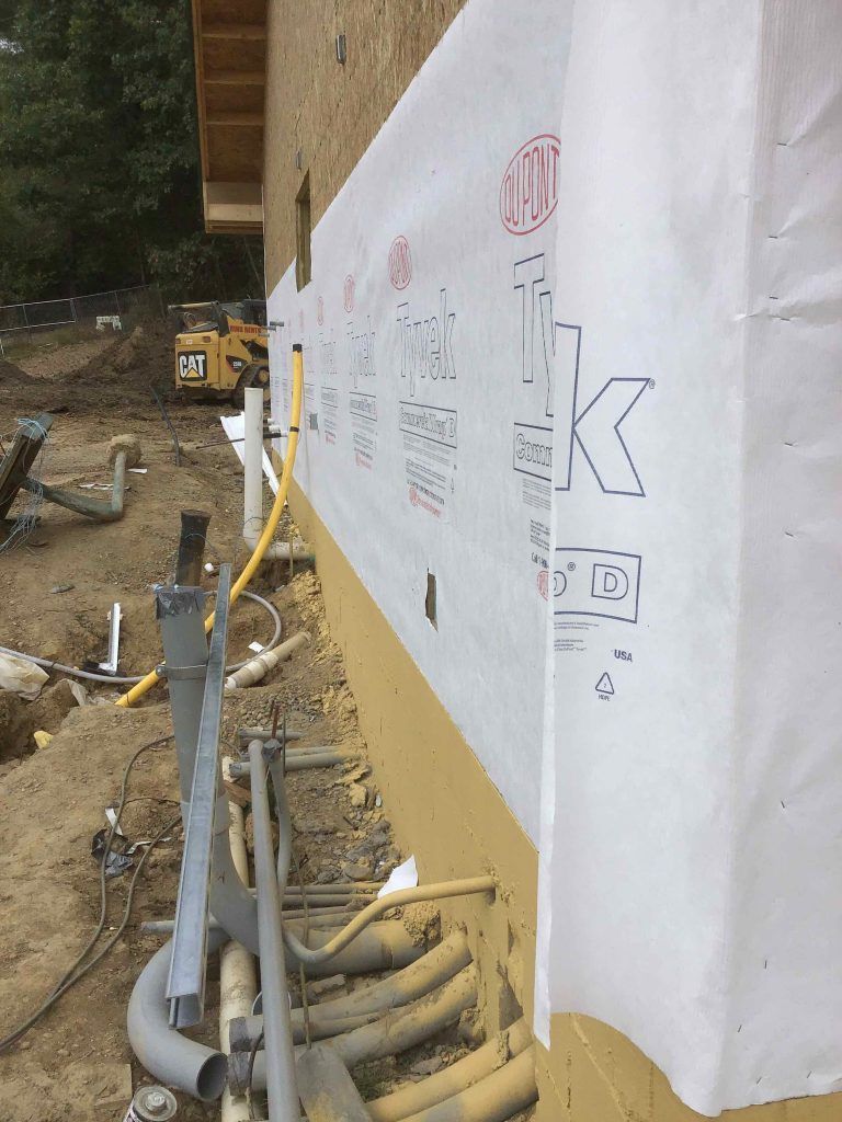 A large piece of paper is covering the side of a building.