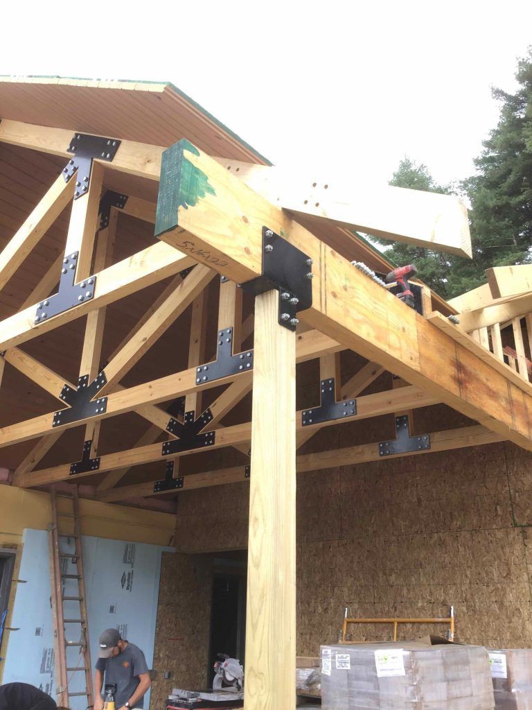 A man is working on the roof of a building.