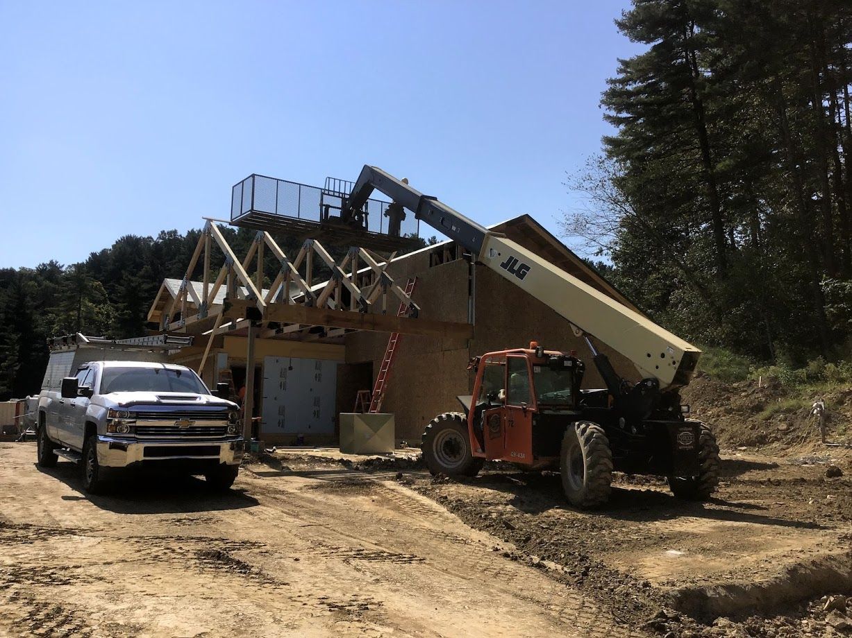 A truck is parked in front of a jlg crane