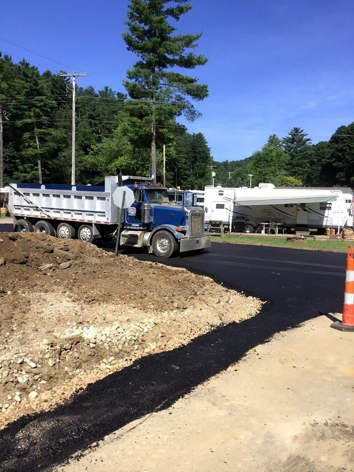 A dump truck is parked on the side of a road.