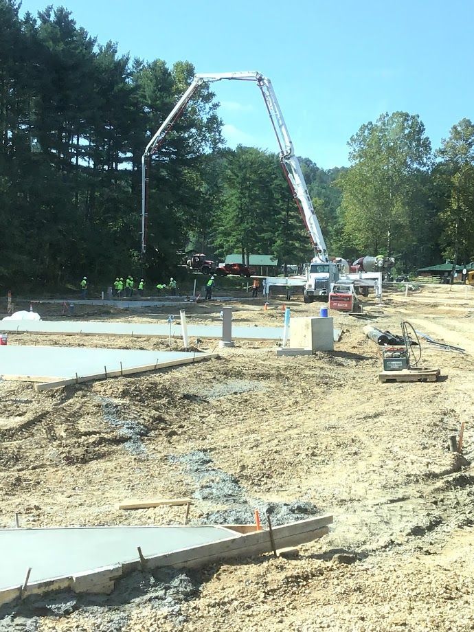 A concrete pump is being used to pour concrete on a construction site.