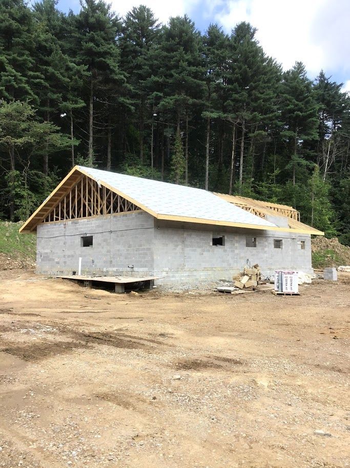 A building is being built in the middle of a forest.