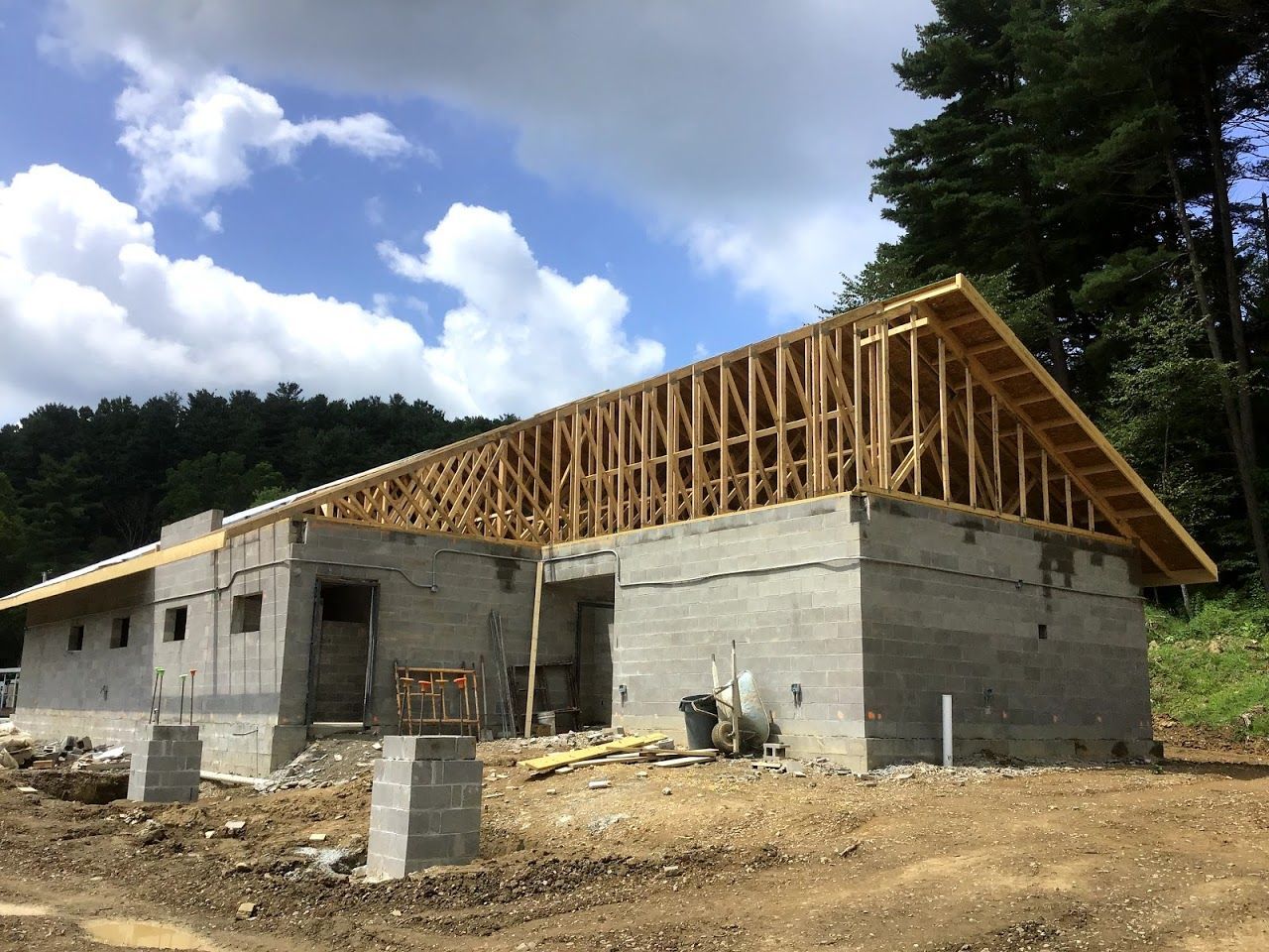 A house that is being built with a wooden roof.