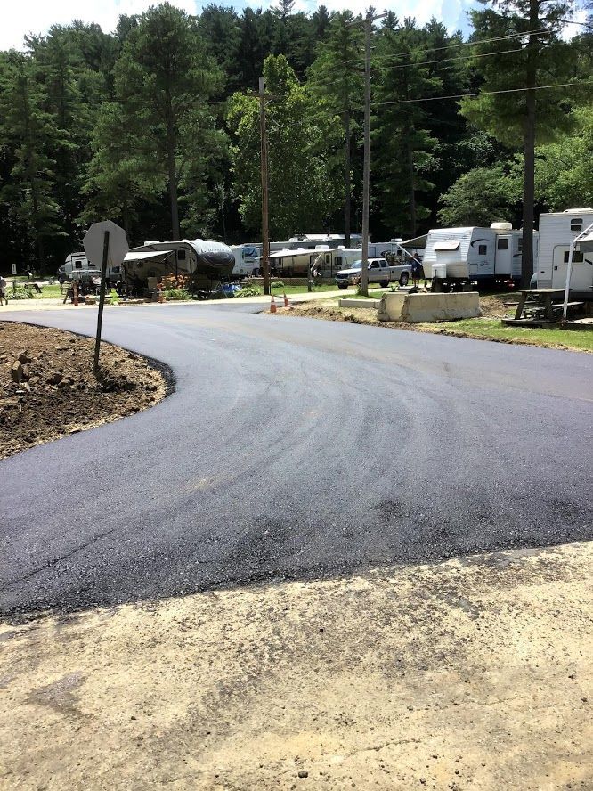 A road with a lot of rvs parked on it.