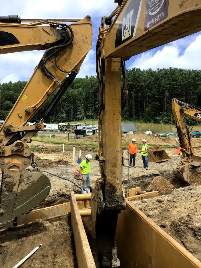A group of construction workers are working on a construction site.
