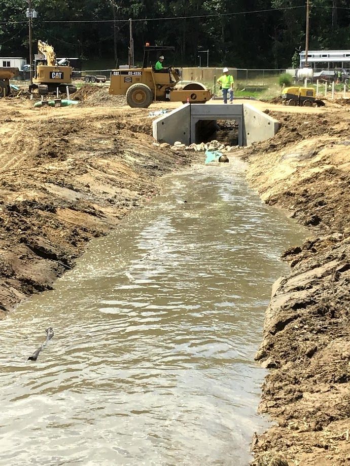 A construction site with a lot of dirt and water.