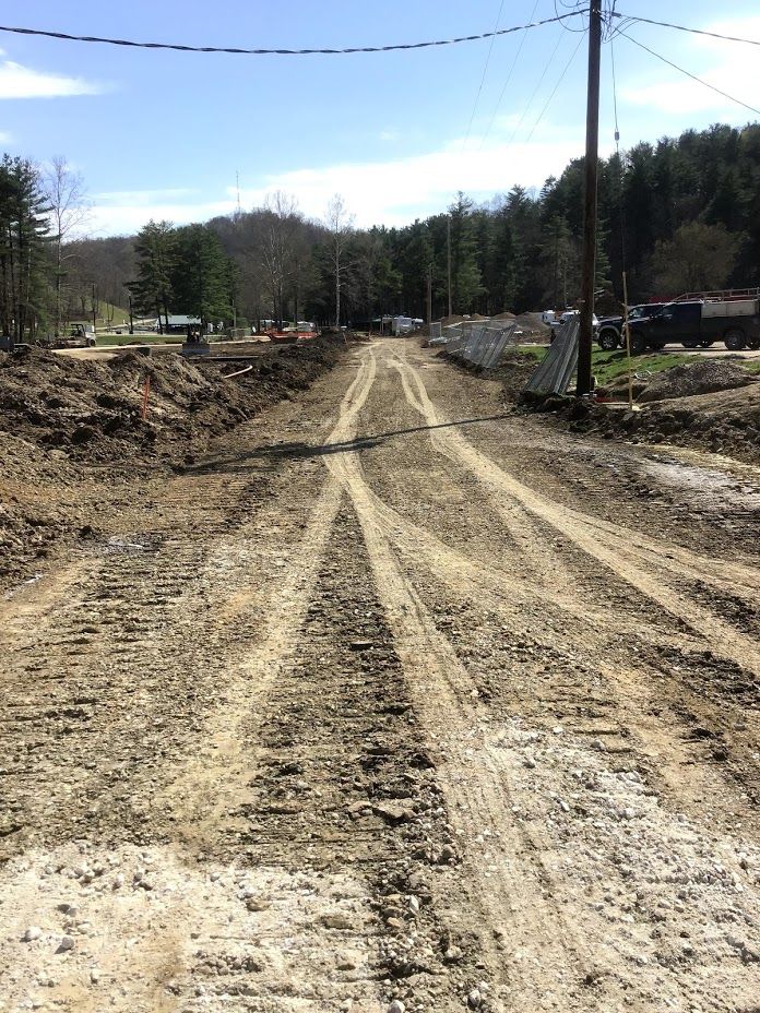 A dirt road with a lot of tire tracks on it