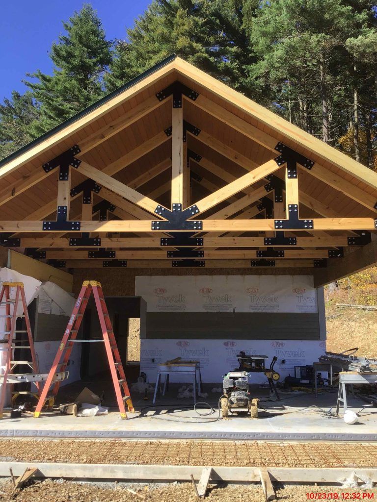 A ladder is sitting in front of a building under construction.