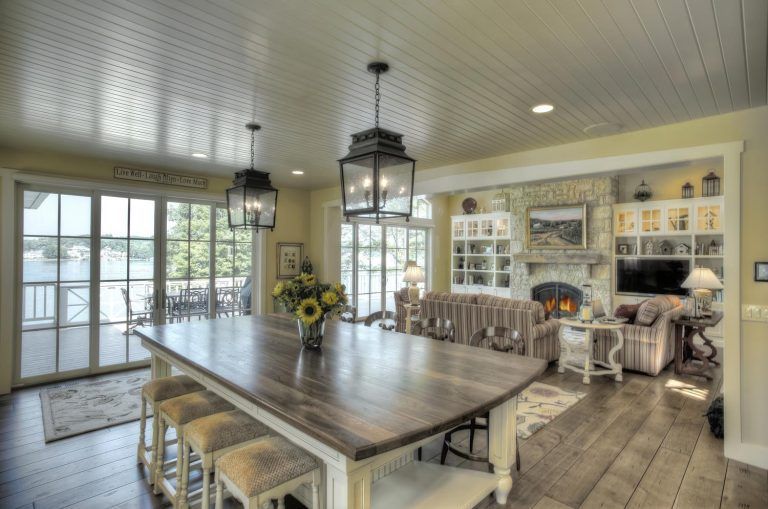 A large wooden table is in the middle of a living room.