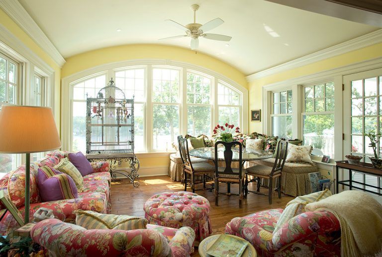 A living room with a lot of furniture and a ceiling fan.