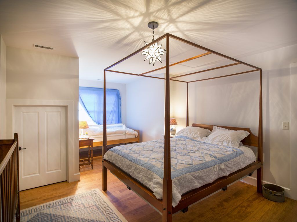 There is a four poster bed in the middle of the room.
