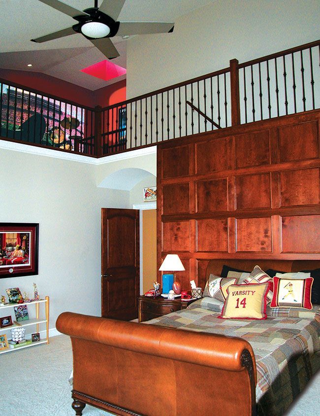 A bedroom with a large bed and a ceiling fan.