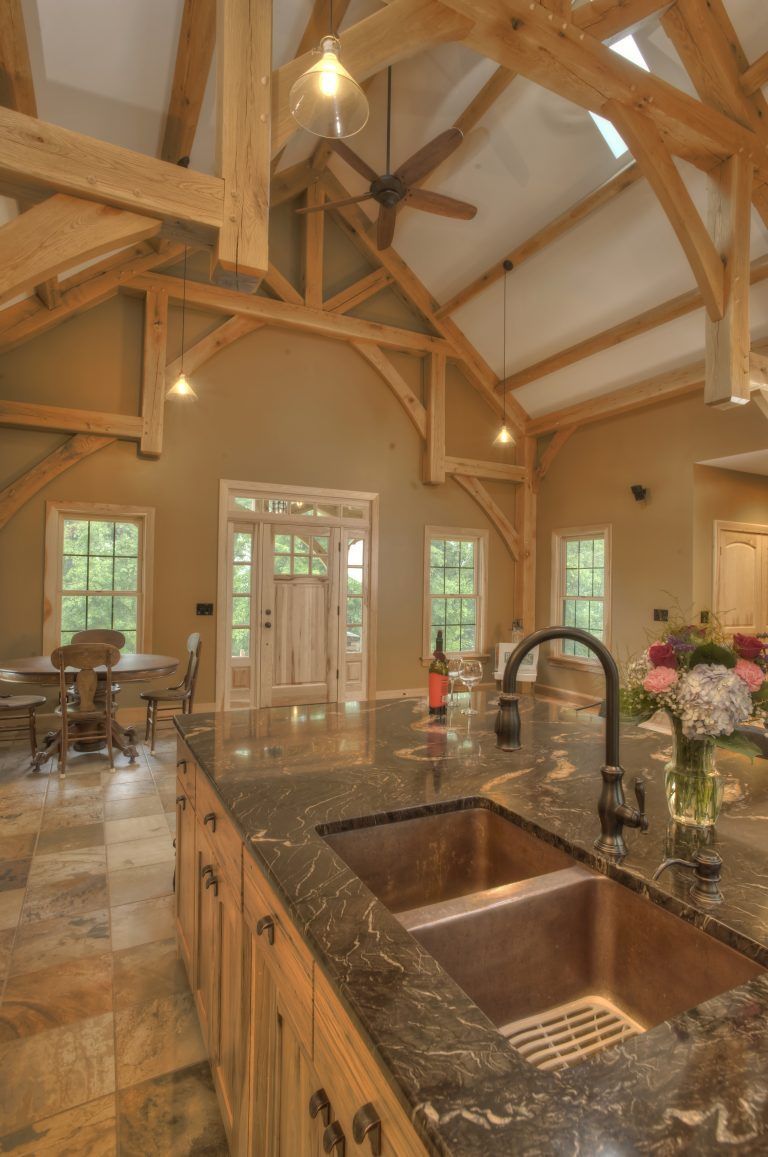 A kitchen with a sink and a ceiling fan