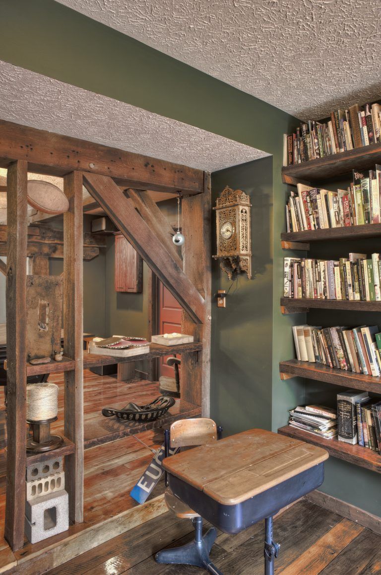 A room with a desk and a clock on the wall.