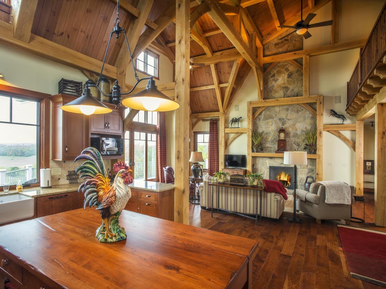 A rooster statue is sitting on a wooden table in a dining room.